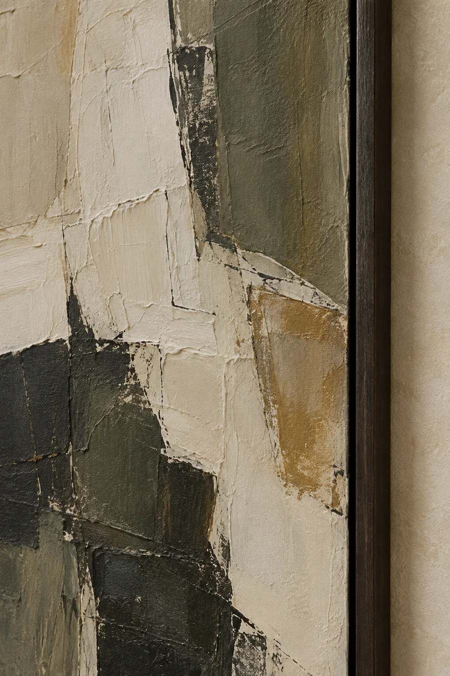 Close detail of a textured abstract canvas in ivory, olive, charcoal and ochre with a dark timber frame